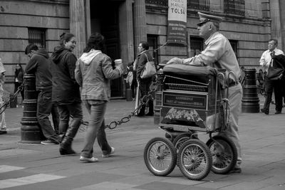 Rear view of people sitting in city