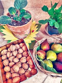High angle view of fruits with walnuts on table
