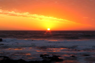 Scenic view of sea against romantic sky at sunset