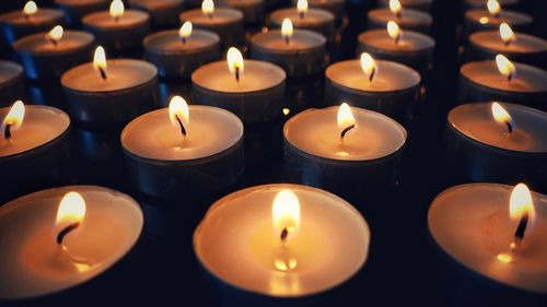 Close-up of lit candles in temple