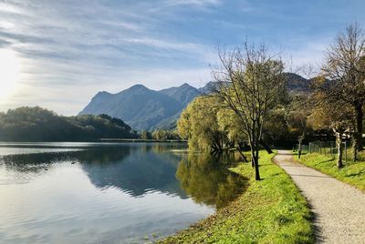 Scenic view of lake by trees against sky