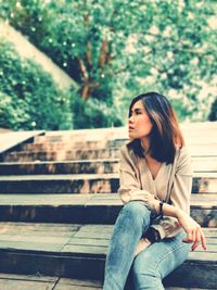 Full length of woman sitting outdoors