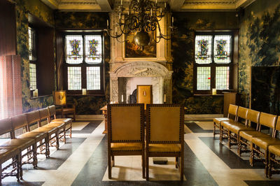 Empty chairs and table in room