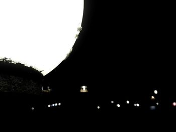 Silhouette of building against clear sky at night