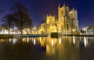 Reflection of illuminated buildings in city at night