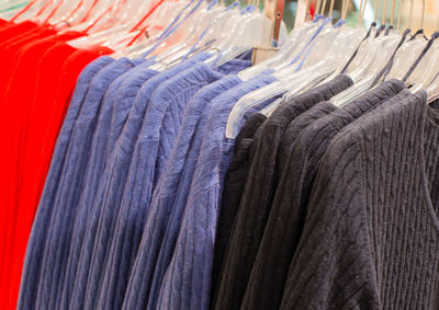 Close-up of clothes hanging on rack in store