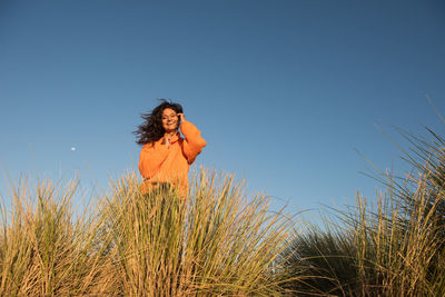 Happy female tourist smiles in the wind