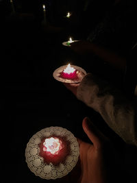 Midsection of person holding illuminated lighting equipment