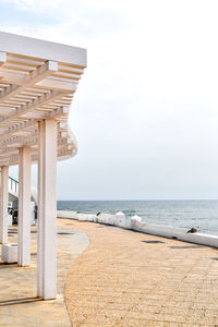 Scenic view of seafront against clear sky