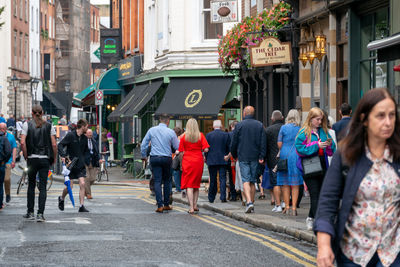 Group of people walking on city street