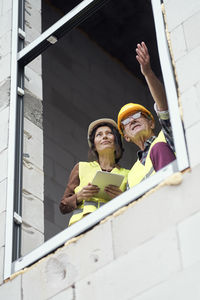 Low angle view of architects at window