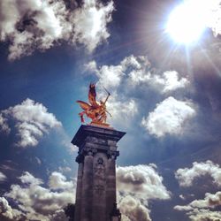 Low angle view of statue against cloudy sky