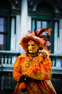 Person wearing venetian mask at carnival