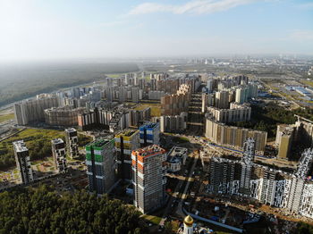 High angle view of modern buildings in city against sky