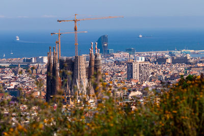 High angle view of buildings by sea against sky