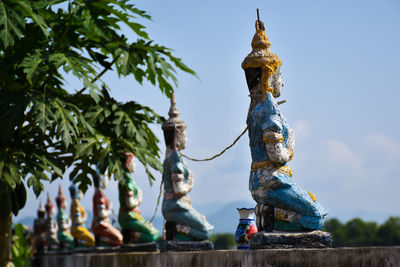 Low angle view of statue against blue sky