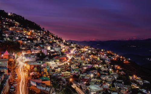 High angle view of city lit up at night