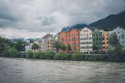 River by buildings against sky in city