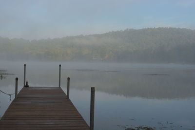 Scenic view of lake in foggy weather