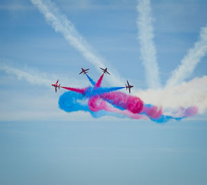 Low angle view of airshow against sky