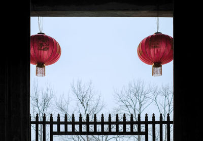 Low angle view of lanterns hanging against sky