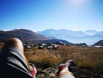 Rear view of man on landscape against sky