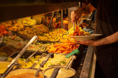 Man holding food at market stall