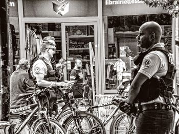 People standing by street in city