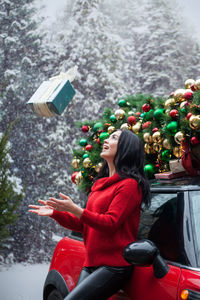 Rear view of woman with christmas tree