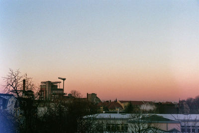 Cityscape against clear sky during sunset