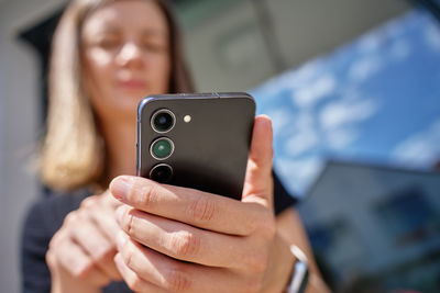Midsection of woman using mobile phone