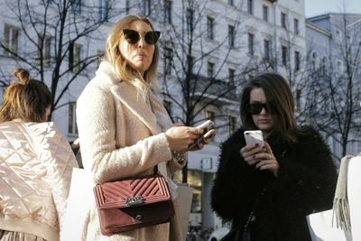 Young woman using mobile phone in city