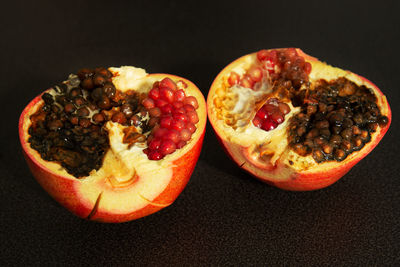 Close-up of fruits on table against black background