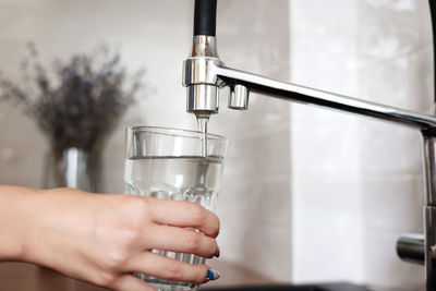 Midsection of woman holding water