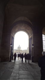 People walking in corridor of building