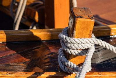 Close-up of moored boat at harbor during sunny day