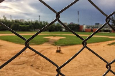 Close-up of chainlink fence against sky