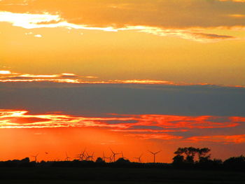 Scenic view of silhouette landscape against romantic sky at sunset