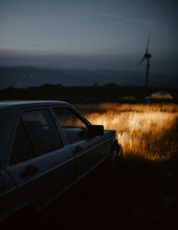 Car on mountain land against night sky