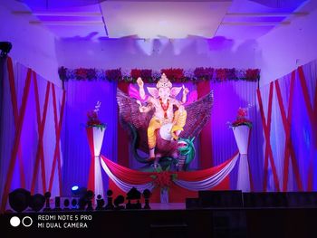 Low angle view of statue against illuminated lights