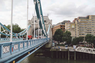 Tower bridge over thames river against sky in city