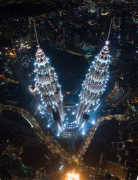 High angle view of city lit up at night