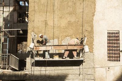 People working at construction site in building