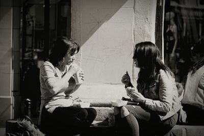 Woman sitting on mobile phone