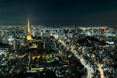 High angle view of illuminated city buildings at night