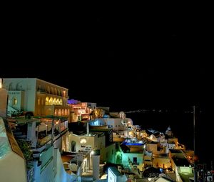 High angle view of illuminated cityscape against sky at night