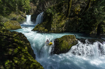 A kayaker descends the little white salmon river in the wa.
