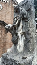 Low angle view of statue against wall