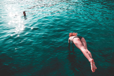 High angle view of woman swimming in sea