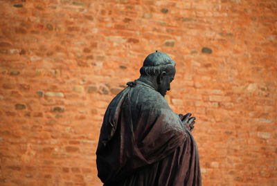 Man standing against wall